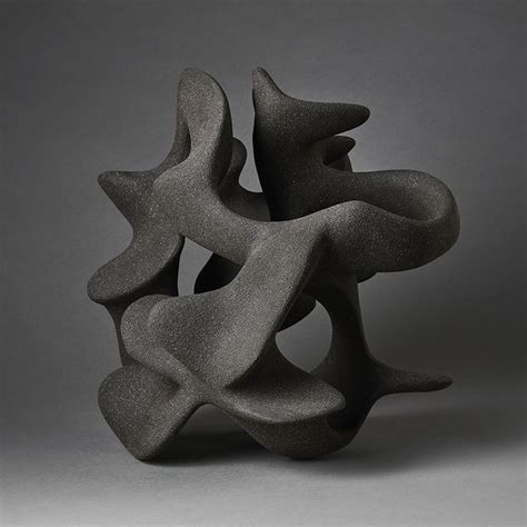 An Abstract Sculpture Is Shown Against A Gray Background