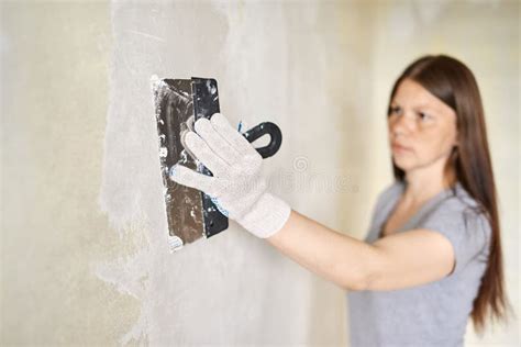 Woman Plastering The Walls With Finishing Putty In The Room Stock Image