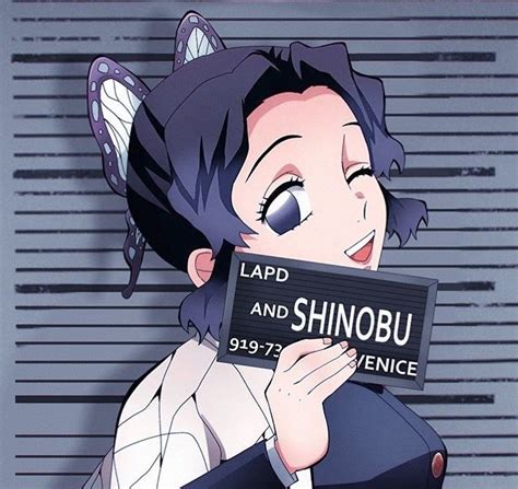 A Woman Holding Up A Sign That Says Lapd And Shinobu In Front Of Her Face