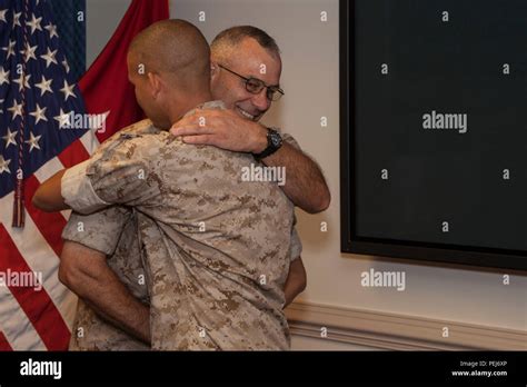 U S Marine Corps Master Gunnery Sgt David K Delcambre Left Hugs A