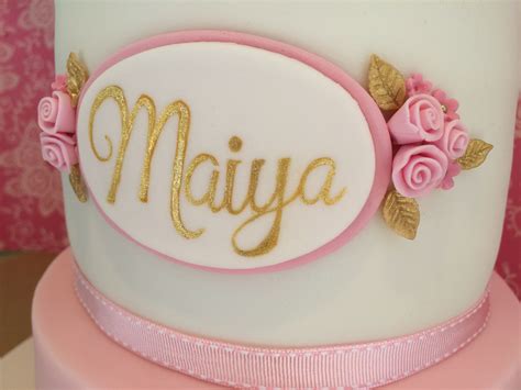 Close Up Of Girls Cake Name Plaque Hand Painted In Gold Fondant Cake