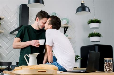 Premium Photo Happy Gay Couple Having Breakfast In Kitchen And Using