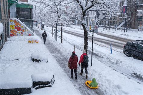 Pedestrians Walking On Saint Denis Street During Snow Storm Editorial