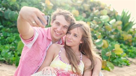 Smiling Young Couple In Love Taking Self Portrait With Camera Phone On