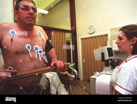Stress Test Nurses Monitoring A Patient Performing Exercise During A