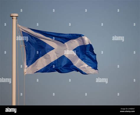 Scottish national flag seen flying attached to a pole Stock Photo - Alamy