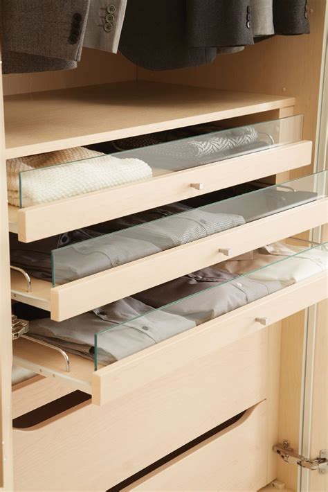 An Organized Closet With Drawers And Clothes