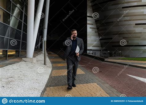 Mature Business Man In A Business Suit Talking On The Phone With A