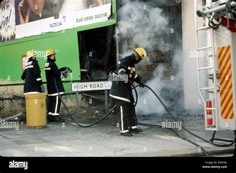 Firemen Extinguishing Fire Stock Photo Alamy