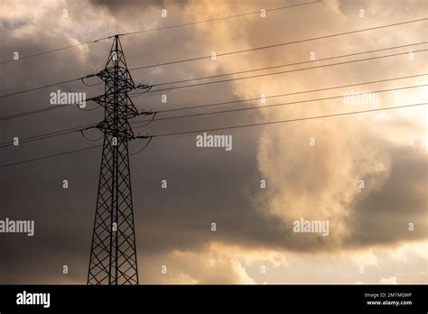 High Voltage Cable Pylons In A Dramatic Cloudy Sunset Stock Photo Alamy