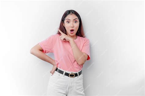 Premium Photo Shocked Asian Woman Wearing Pink Tshirt Pointing At The Copy Space On Beside Her