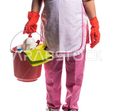 Close Up Of A Cleaning Lady Wearing Gloves And Apron Holding A Bucket Of Household Cleaning