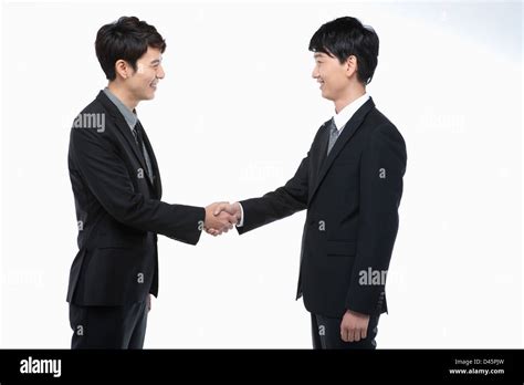 Two Young Businessmen Shaking Hands Stock Photo Alamy