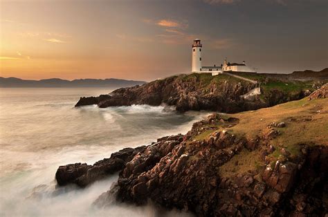 Lighthouse On Foggy Coastline by George Karbus Photography