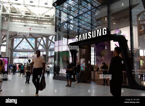 Shoppers Pass By The Front Of A Samsung Experience Store In Toronto