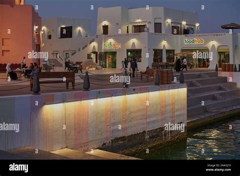 Old Doha port (Mina District) in Doha, Qatar night shot showing café ...