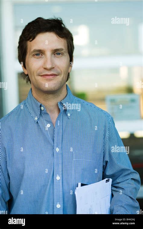 Man carrying documents under arm, portrait Stock Photo - Alamy