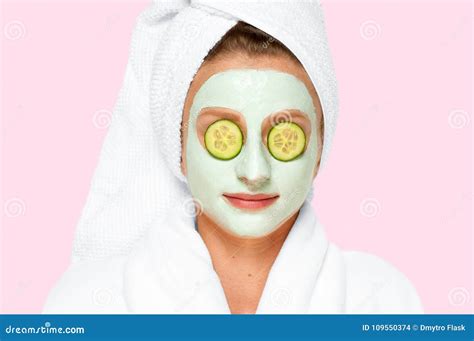 Beauty Spa Woman With Facial Clay Mask And Cucumbers On Eyes Stock