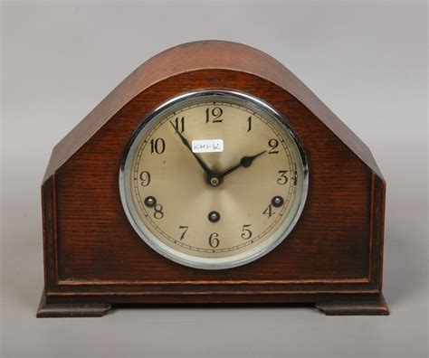 An Oak Cased Westminster Chime Mantel Clock With Key And Pendulum By