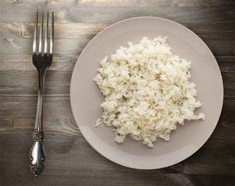 White Rice On A Plate Rice On A Wooden Background Top View Stock Photo