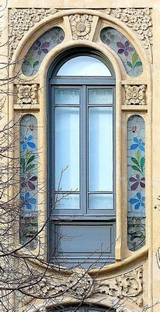 An Arched Window With Blue Flowers Painted On The Side And Below It Is