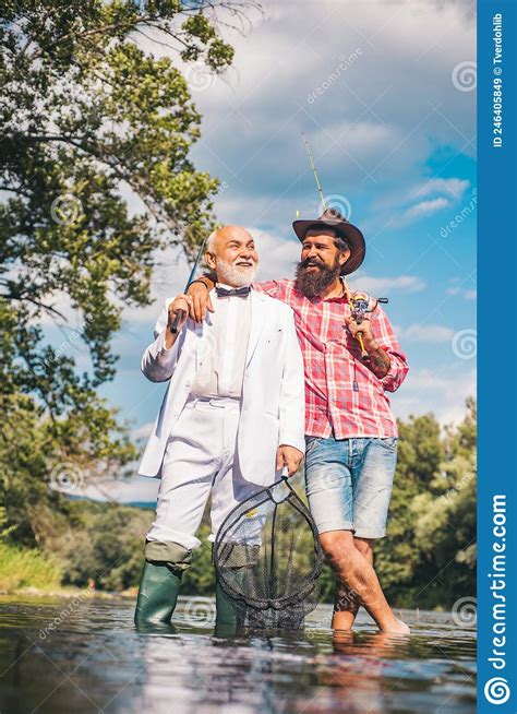 Father And Mature Son Fisherman Fishing With A Fishing Rod On River