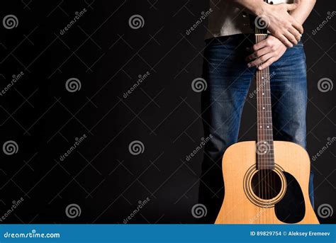 Guitarist Holding Two Hands With An Acoustic Guitar On A Black Isolated