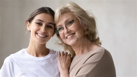 Head Shot Portrait Middle Aged Mother With Adult Daughter Hugging Stock