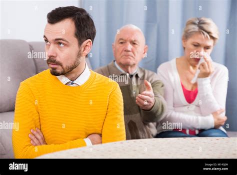 Mature Father And Mother Quarrelling With Their Son At Home Stock Photo Alamy