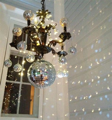 A Chandelier With Disco Balls Hanging From It S Ceiling In Front Of A