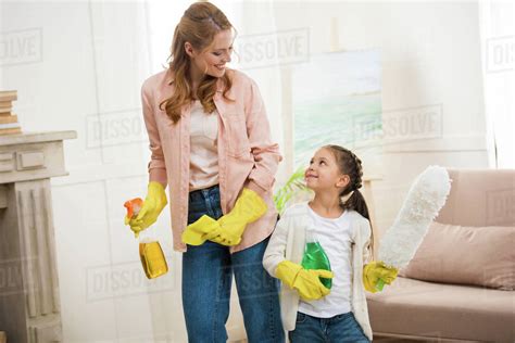 Happy Mother And Daughter Cleaning Room And Smiling Each Other Stock