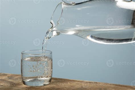 Person Filling A Cup Of Water With A Jar 12190442 Stock Photo At Vecteezy