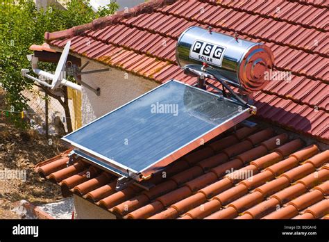 Domestic Solar Panel Water Heater On Tiled Roof Of House At Assos On