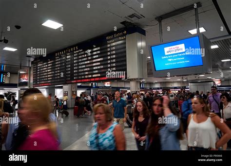 People Inside Of Penn Station With Departure Information Screen In