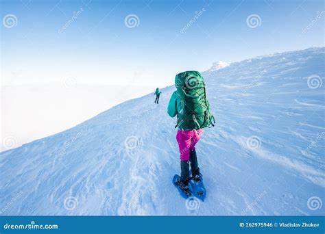 Climbers Climb The Tower In Daylight With A Blue Sky Background Stock