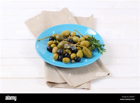 Plate Of Pickled Olives Capers And Caper Berries Stock Photo Alamy