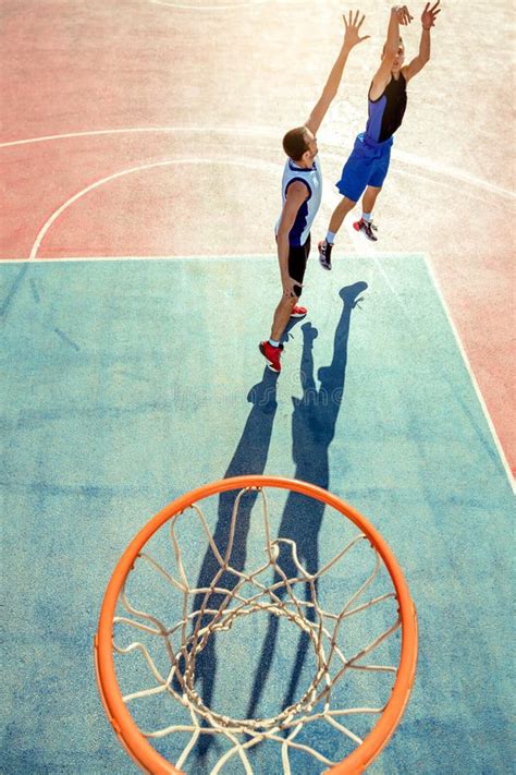 High Angle View Of Basketball Player Dunking Basketball In Hoop Stock