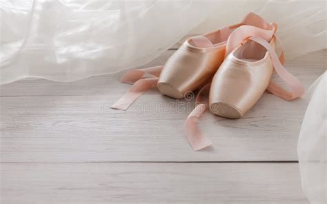 Pink Ballet Pointe Shoes And Tutu On White Wood Background Stock Photo