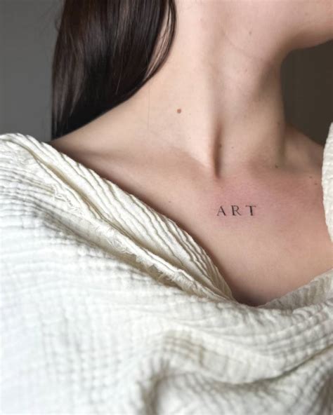 Tattoo Of The Word Art Located On The Collarbone