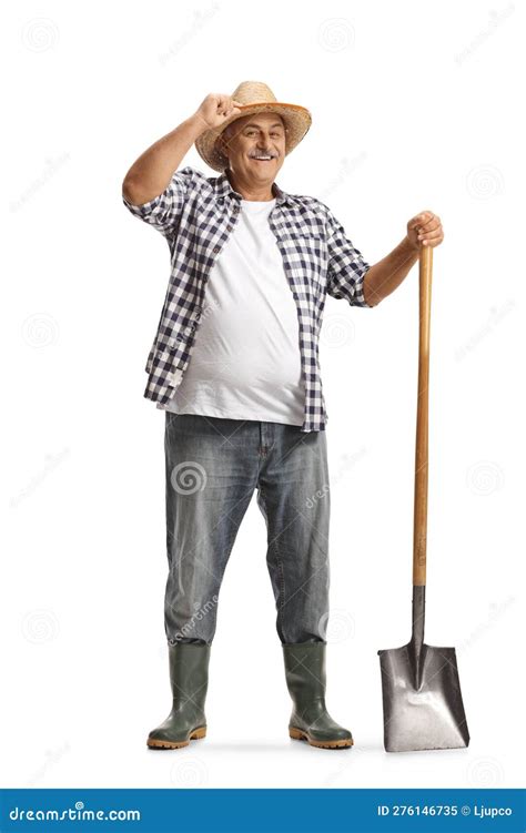 Full Length Portrait Of A Happy Mature Farmer With A Shovel Greeting