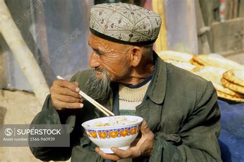 China Xinjiang Province Kashi Kashgar Uyghur Man Eating SuperStock