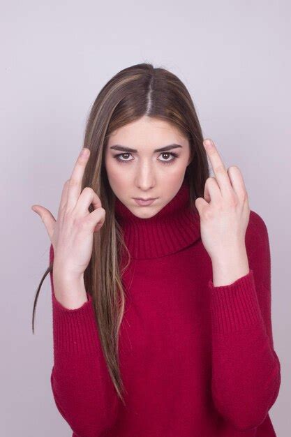 Premium Photo Portrait Of Young Woman Showing Middle Fingers Against