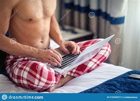 Cropped Image Of Attractive Shirtless Caucasian Male Sitting On Bed