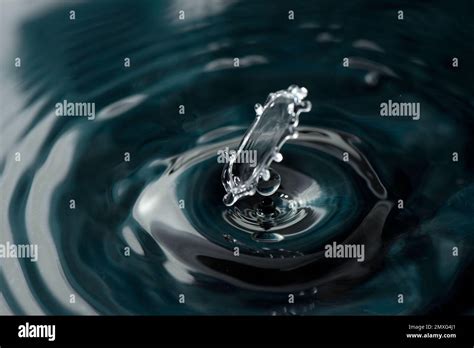 A Closeup Of Droplets Falling Into The Rippling Water Stock Photo Alamy