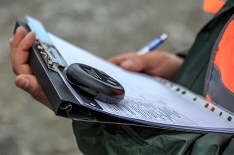 Premium Photo Midsection Of Engineer Holding Clipboard