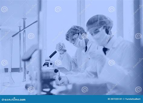 Close Up Group Of Scientists Conduct Research In The Laboratory Stock