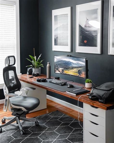 A Desk With A Computer Chair And Pictures On The Wall In Front Of It