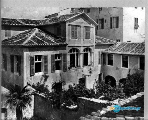 An Old Building With Windows And Shutters On The Roof Is Shown In This