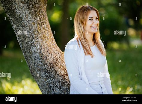 Beautiful Brunette Posing And Smiling In Nature Stock Photo Alamy