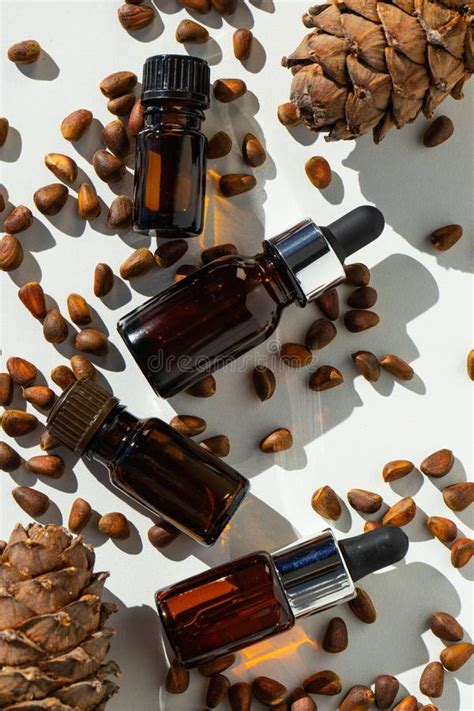 Cedar Essential Oil In Small Glass Bottles On A White Background Cedar